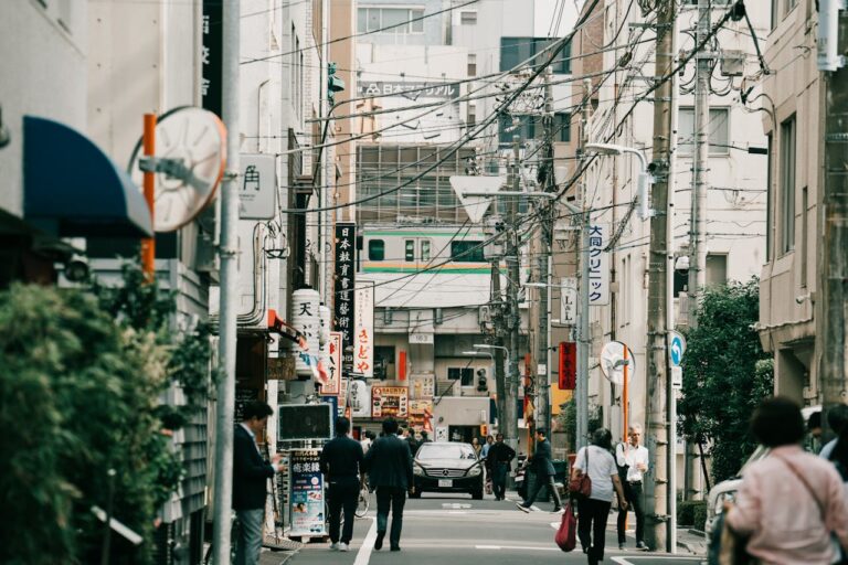 Vibrant street view in urban Japan with pedestrians and signage capturing cultural essence.