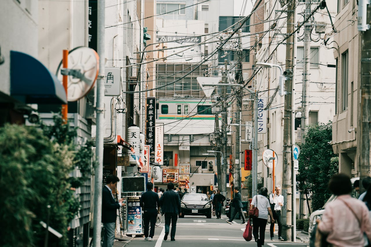 portfolio-03 Vibrant street view in urban Japan with pedestrians and signage capturing cultural essence.