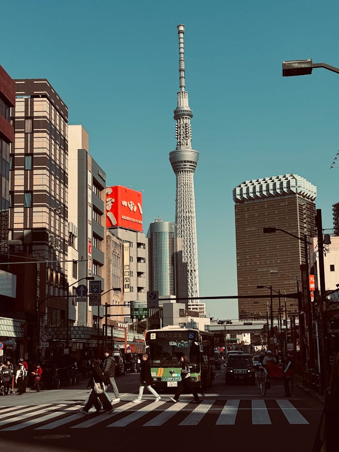 portfolio-01 A bustling street scene in Tokyo with the iconic Skytree tower and vibrant urban life.